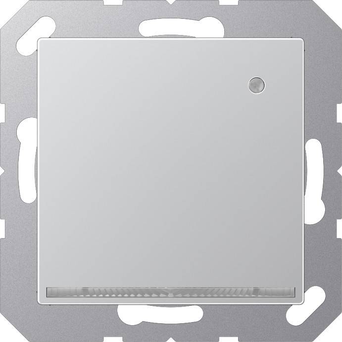 Eine Nahaufnahme eines modernen, quadratischen, silbernen Lichtschalters mit einem kleinen runden Indikator in der oberen rechten Ecke, montiert auf einer Metallplatte.