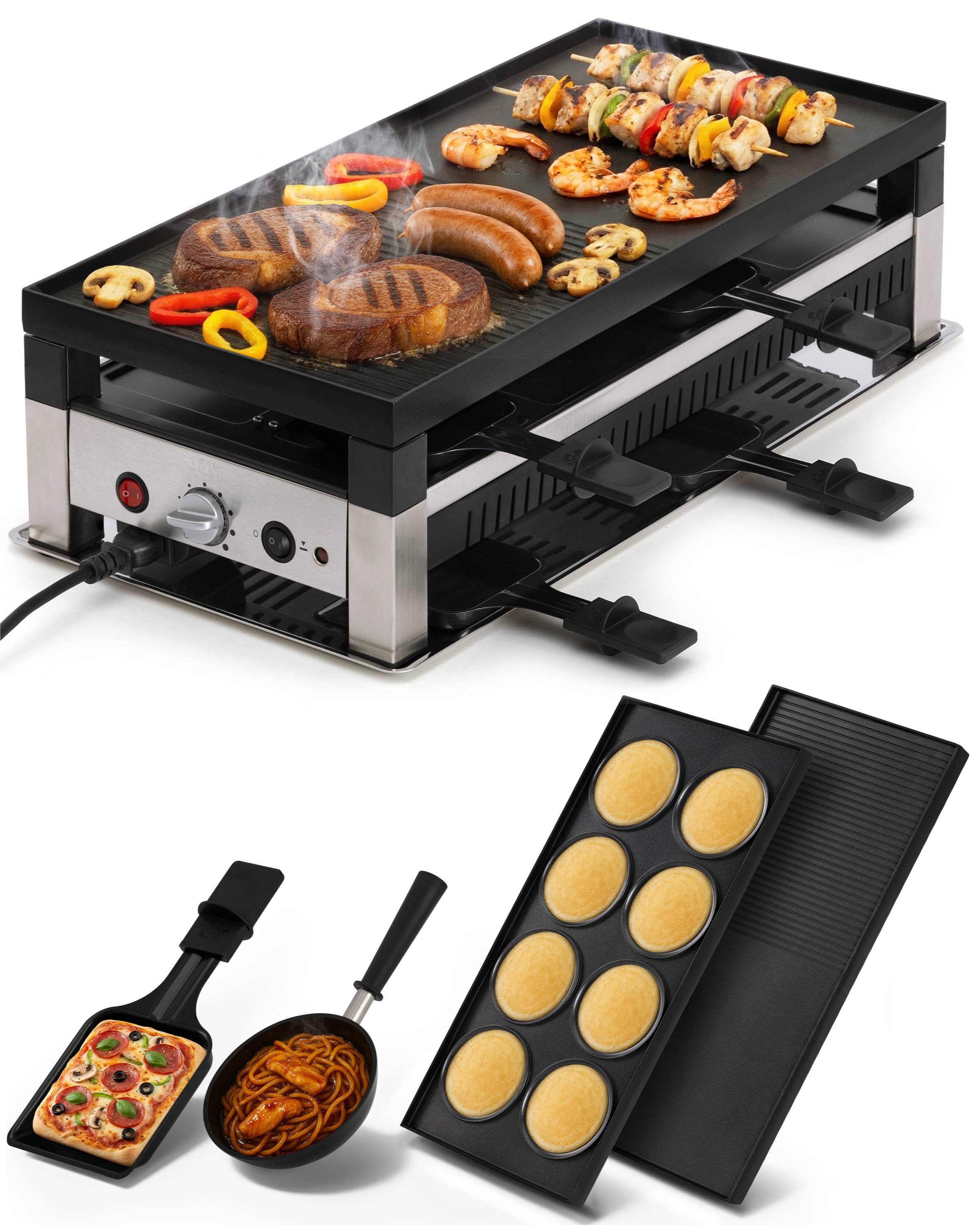Elektrischer Tischgrill mit Spießen, Würstchen, Steaks und Gemüse auf der Oberseite, plus abnehmbare Grillplatten und kleine Pfannen für Eier und Lebensmittel.