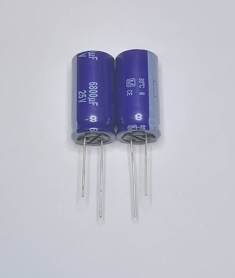 Zwei blaue Elektrolytkondensatoren mit je drei Drahtanschlüssen, beschriftet mit 6800µF 25V, auf weißem Hintergrund.