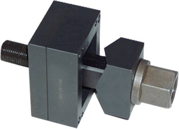 Ein Metallblock mit einer zentralen Nut und quadratischen Backen auf einer Stange, wahrscheinlich Teil eines mechanischen oder industriellen Werkzeugs, in Nahaufnahme dargestellt.