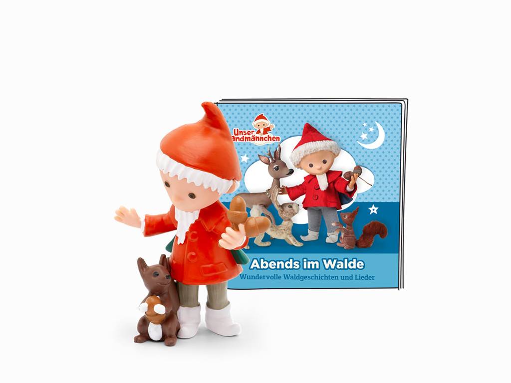 Spielzeug-Elfenfigur vor einem blauen Kinderbuch mit dem Titel „Abends im Walde