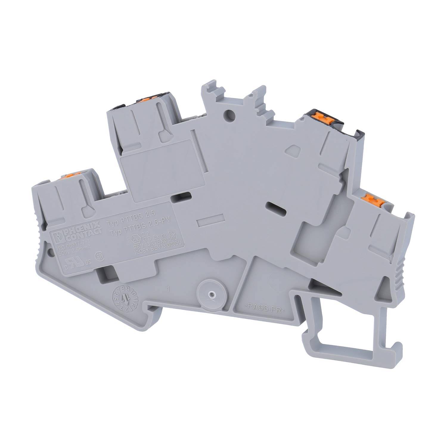 Ein grauer Klemmenblock mit orangefarbenen Anschlusspunkten, der zum Befestigen und Organisieren von Kabeln in elektrischen Installationen verwendet wird.