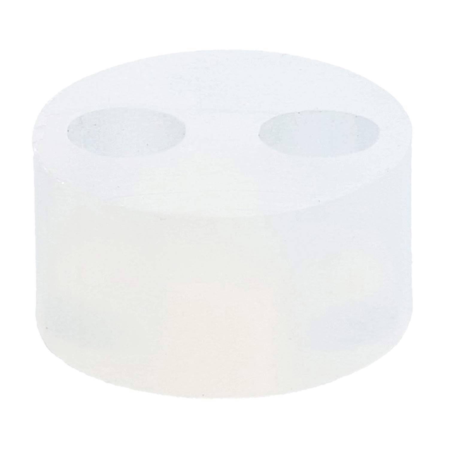 Ein weißer zylindrischer Gegenstand mit zwei runden Löchern auf seiner Oberseite.