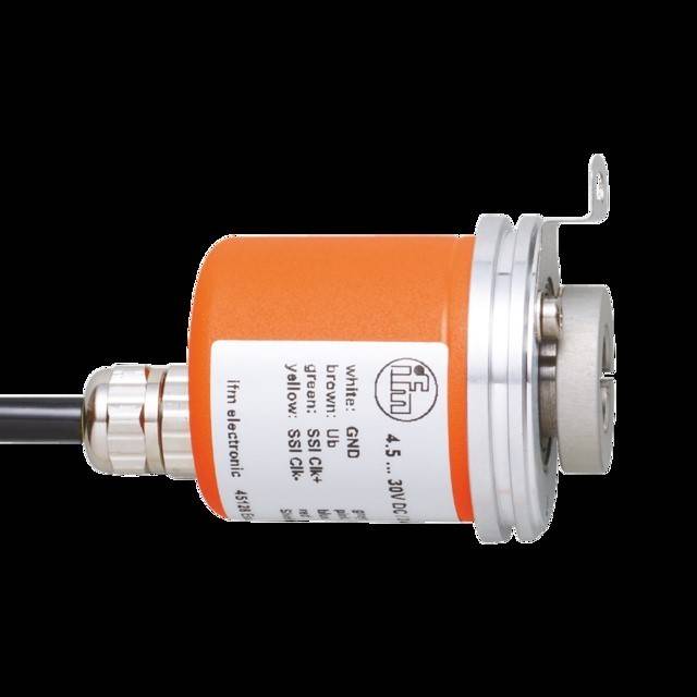 Ein zylindrisches orangefarbenes Sensorgehäuse mit Anschlüssen und beschrifteten Kabeln. Die Beschriftung erwähnt GND, 24V DC, Klasse 2 und Farbcodes für die Verbindung.