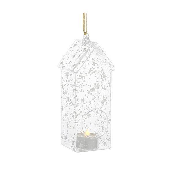 Eine dekorative, sternförmig gemusterte Laterne in Hausform, die an einem goldenen Faden hängt, mit einer kleinen Kerze im Inneren.