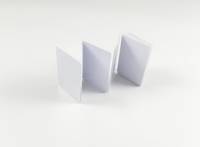 Ein Papierakkordeon in drei Abschnitten, aufrecht vor einem schlichten weißen Hintergrund stehend.