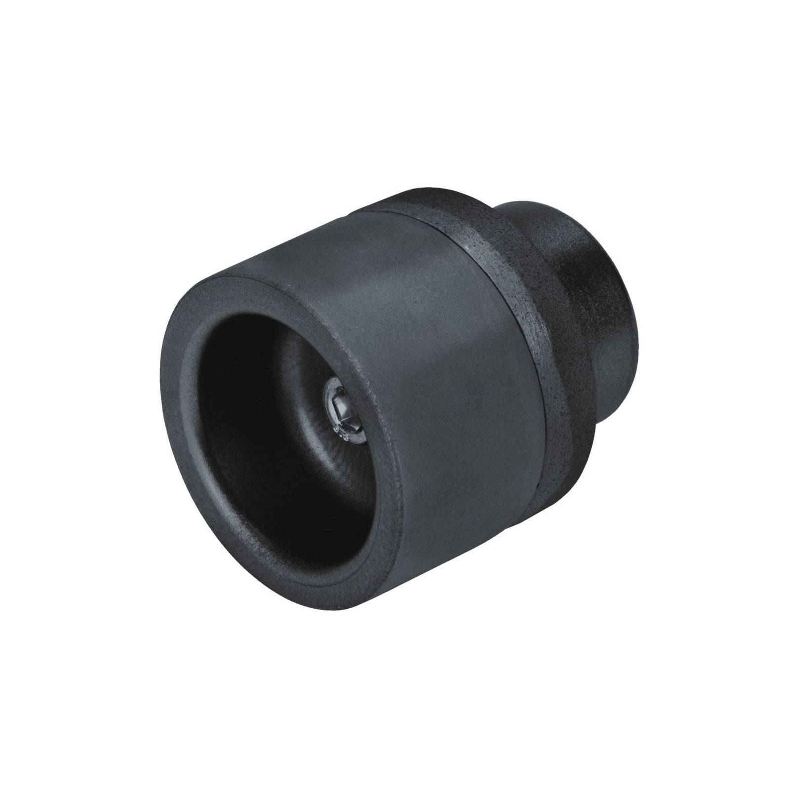 Ein schwarzer zylindrischer Aufsatz mit einem hohlen Zentrum, höchstwahrscheinlich ein Teil eines industriellen Werkzeugs, liegt vor einem einfarbigen Hintergrund.