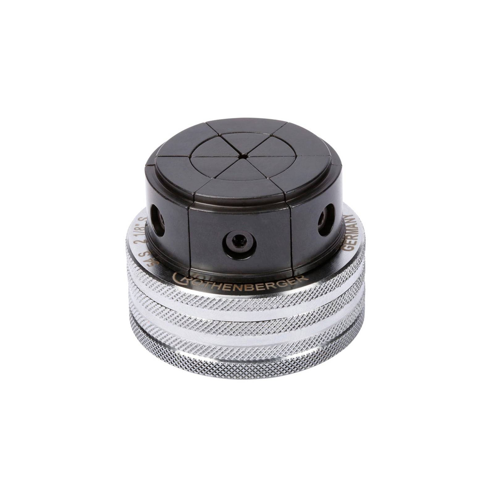 Ein kompaktes metallisches Werkzeug mit einem schwarzen rotierenden Deckel, das vier kreisförmige Vertiefungen und einen gerifften silbernen Griff aufweist, das für präzise Einstellungen verwendet wird.