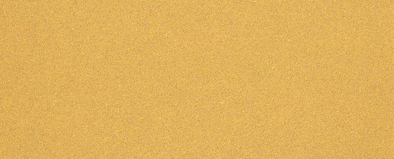 Ein Nahaufnahmebild einer sandbeigen texturierten Oberfläche, die feinem Schleifpapier oder Wüstensand ähnelt, mit einer gleichmäßigen und körnigen Erscheinung.