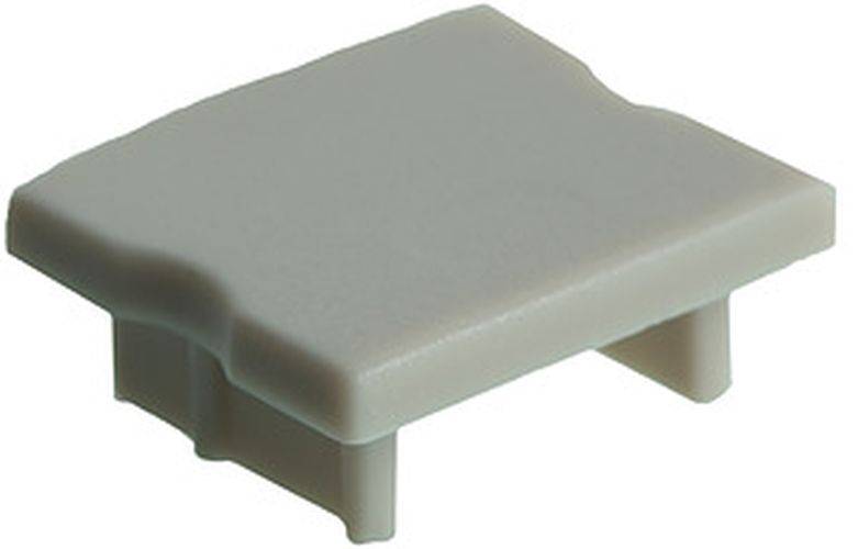 Ein kleines, rechteckiges, beiges Plastikbauteil mit kurzen Beinen und einer flachen Oberfläche, das einer Abdeckung oder einem Deckel ähnelt. Zweck und Kontext wurden nicht näher erläutert.