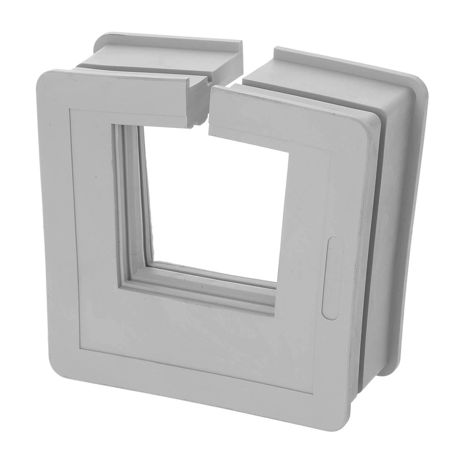 Ein graues, quadratisches Kunststoffobjekt mit zwei Teilen, die ineinander zu greifen scheinen. Es hat eine zentrale quadratische Öffnung und seitliche Schlitze zur Montage.
