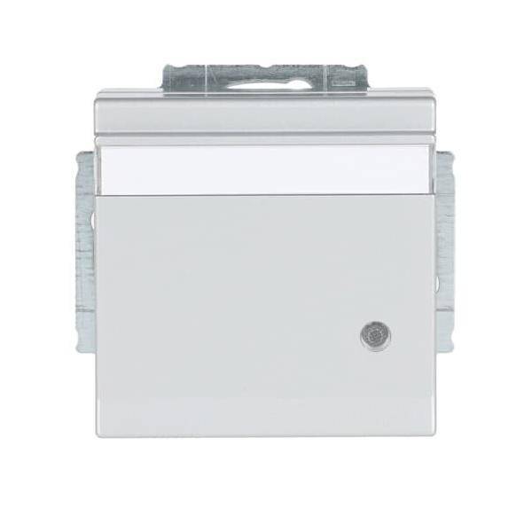 Ein weißes elektrisches Schaltpanel mit einem metallischen Rahmen und einem kleinen runden Knopf in der unteren rechten Ecke.