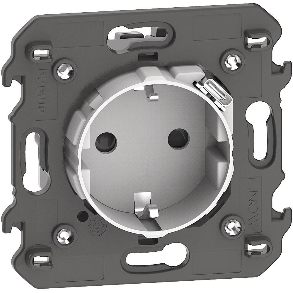 Eine Wandsteckdose mit einer runden, eingelassenen Buchse ist zu sehen, umrahmt von einem Metallrahmen mit Bohrlöchern zur Befestigung.