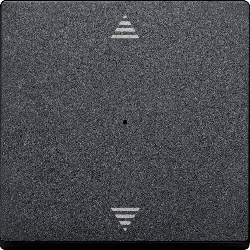 Ein schwarzes, strukturiertes quadratisches Panel mit einem kleinen Punkt in der Mitte und weißen Pfeilsymbolen, die nach oben und unten zeigen, höchstwahrscheinlich eine Steuerungstaste.