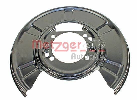 Ein runder, metallischer Autoteil mit Löchern und Rillen, mit der Aufschrift 'Metzger Autoteile', höchstwahrscheinlich ein Bremsschild oder eine ähnliche Fahrzeugkomponente.