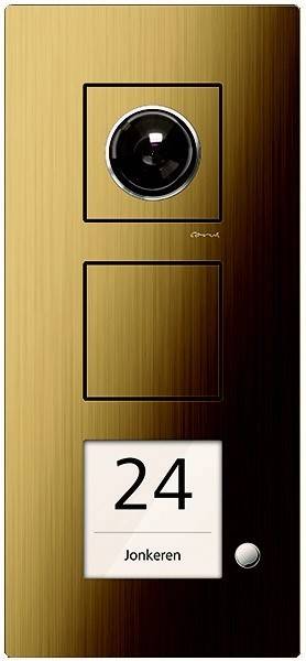 Ein goldenes quadratisches Türsprechanlage-Panel mit einer Kamera und zwei Tasten. Die Zahl '24' ist am unteren Rand angezeigt.