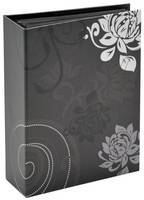 Schwarze dekorative Geschenkbox mit weißen Blumen- und Schnörkelmotiven auf der Vorder- und Seitenseite.