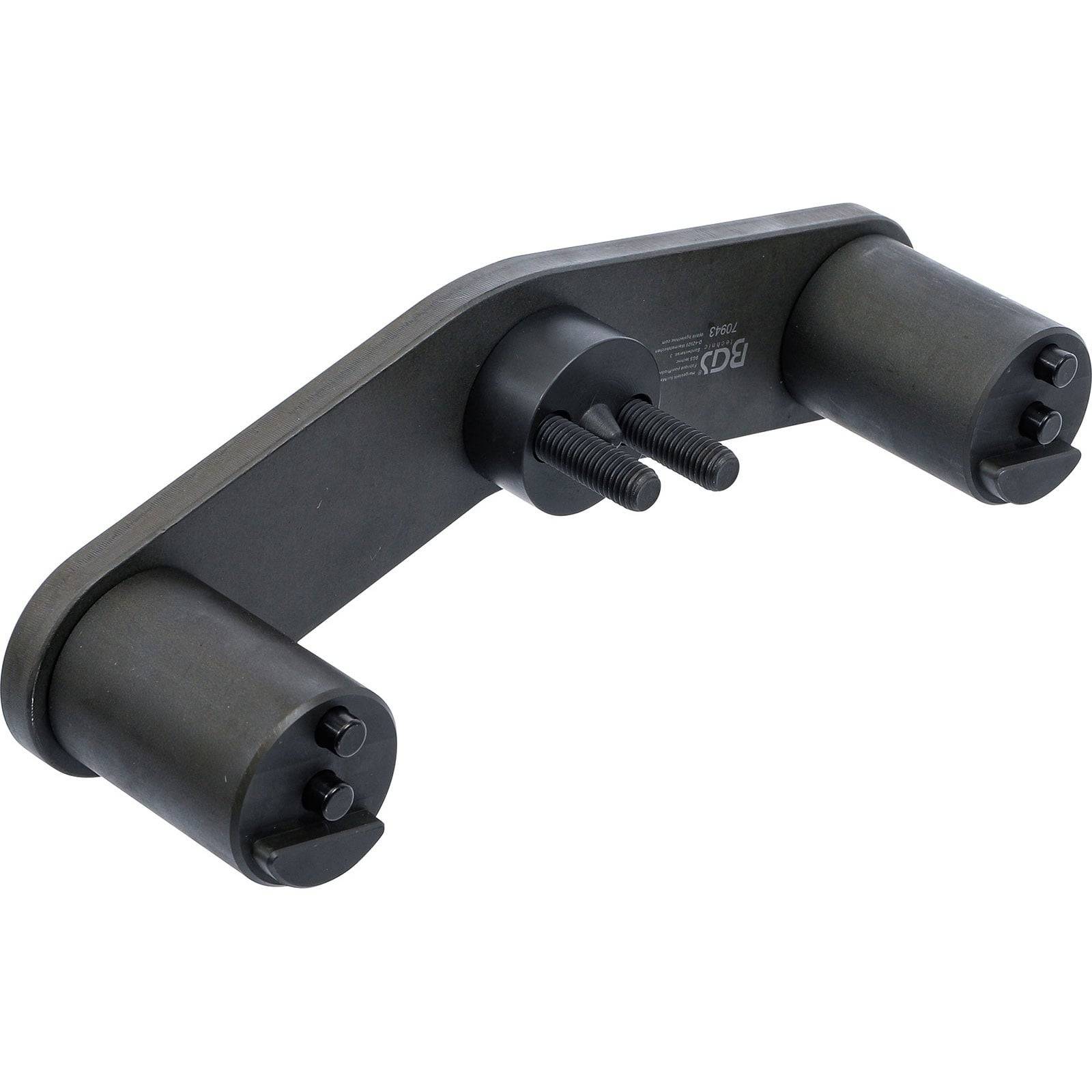 Ein schwarzes metallisches Autowerkzeug mit zwei zylindrischen Teilen und Schrauben, das zur Einstellung der Motorzeitsteuerung verwendet wird.