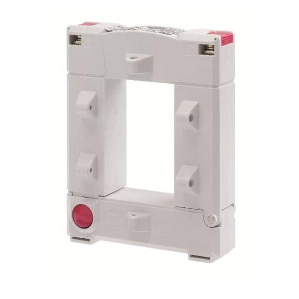 Eine rechteckige weiße elektrische Komponente mit Befestigungsbügeln und einer kreisrunden roten Markierung in der unteren linken Ecke.