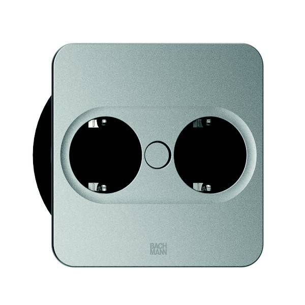 Eine Doppelsteckdose mit elegantem, modernem Design, ausgestattet mit zwei kreisförmigen Steckplätzen auf einer quadratischen Metallplatte, geeignet für den Einsatz in Haus oder Büro.