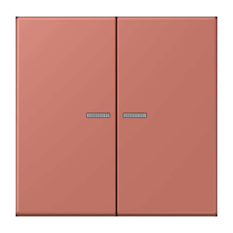 Ein rechteckiges, zweischalteriges Lichtpanel in gedecktem Rosenton mit kleinen, rechteckigen silbernen Griffen, die auf jedem Schalter zentriert sind.