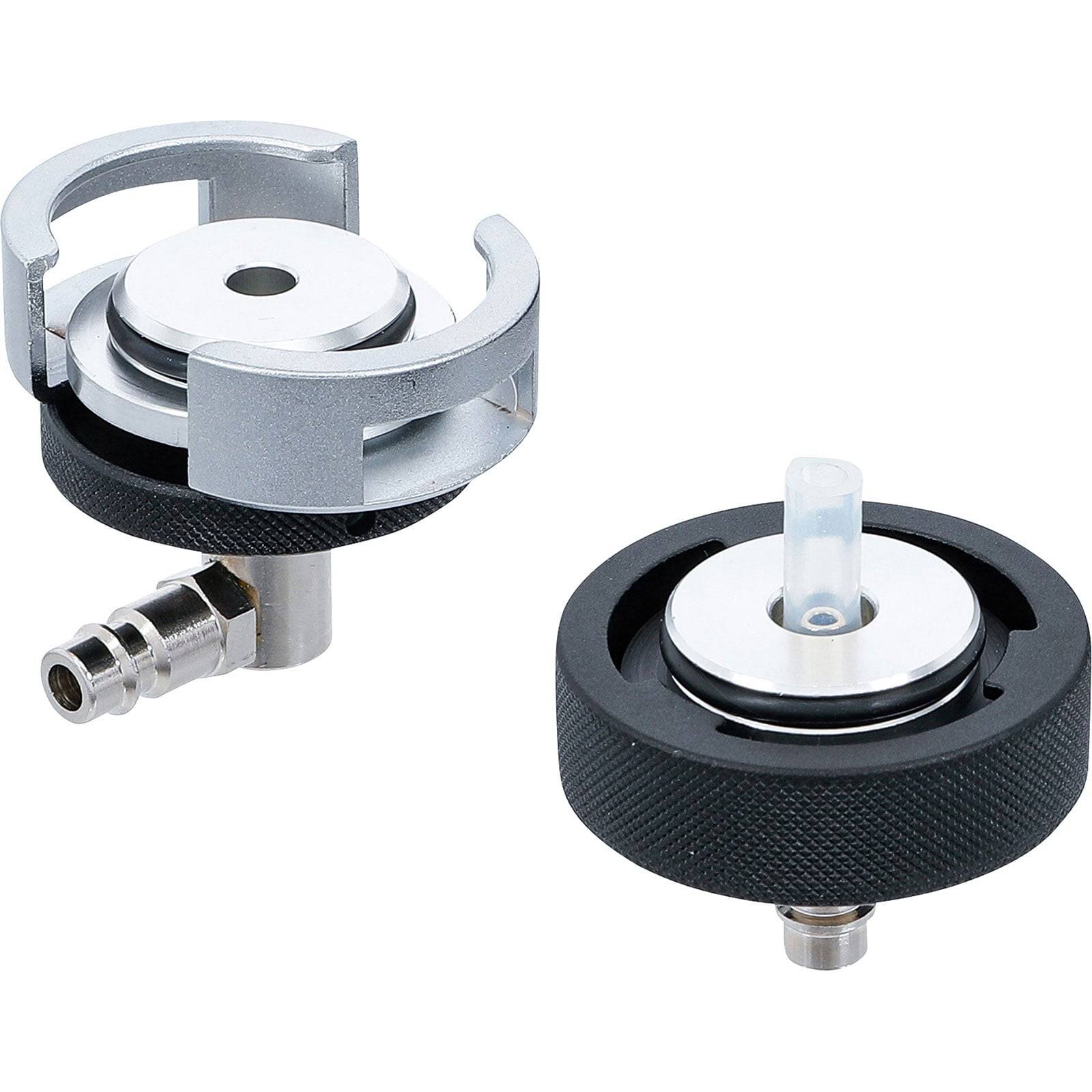 Zwei Ventilverbinder aus Metall und Kunststoff mit kreisförmiger Gestaltung, seitlichen Klammern und zentralen Öffnungen, aus verschiedenen Blickwinkeln dargestellt.