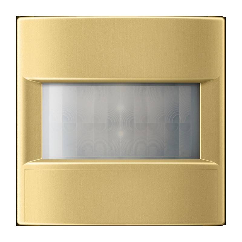 Ein goldener rechteckiger Bewegungssensor mit einer zentrierten transluzenten Linse, konzipiert für Heimautomatisierungssysteme, vor einem schlichten Hintergrund.