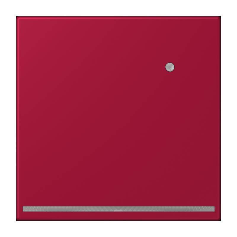 Roter Stopptaster mit einem kleinen kreisförmigen Indikator, vor einem einfarbigen roten Hintergrund.