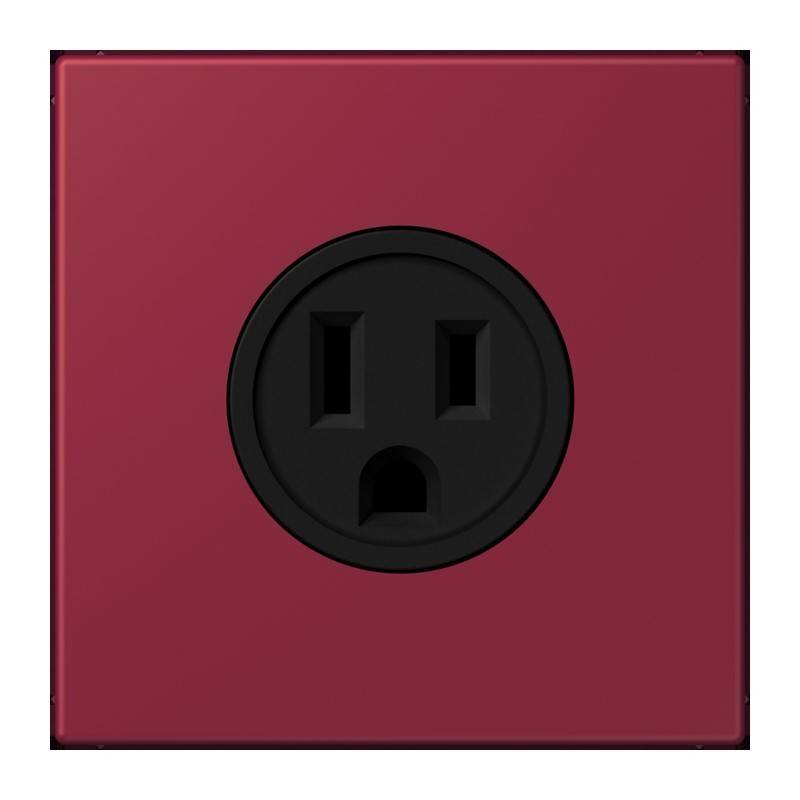 Eine rote elektrische Wandsteckdose mit einer schwarzen, zweifach Steckdose auf einer flachen Oberfläche.