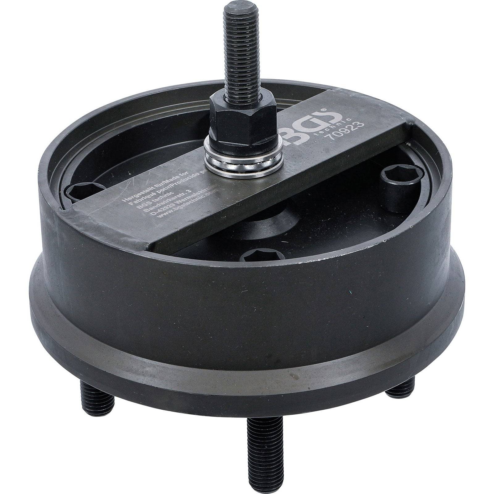 Ein Metallwerkzeug mit runder Grundfläche, zentraler Schraube und zwei seitlichen Schrauben, das zum Abziehen oder Einpassen von mechanischen Teilen verwendet wird.