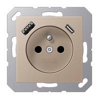 Eine beige Steckdose mit zwei USB-Anschlüssen, die an einem Metallrahmen montiert ist.