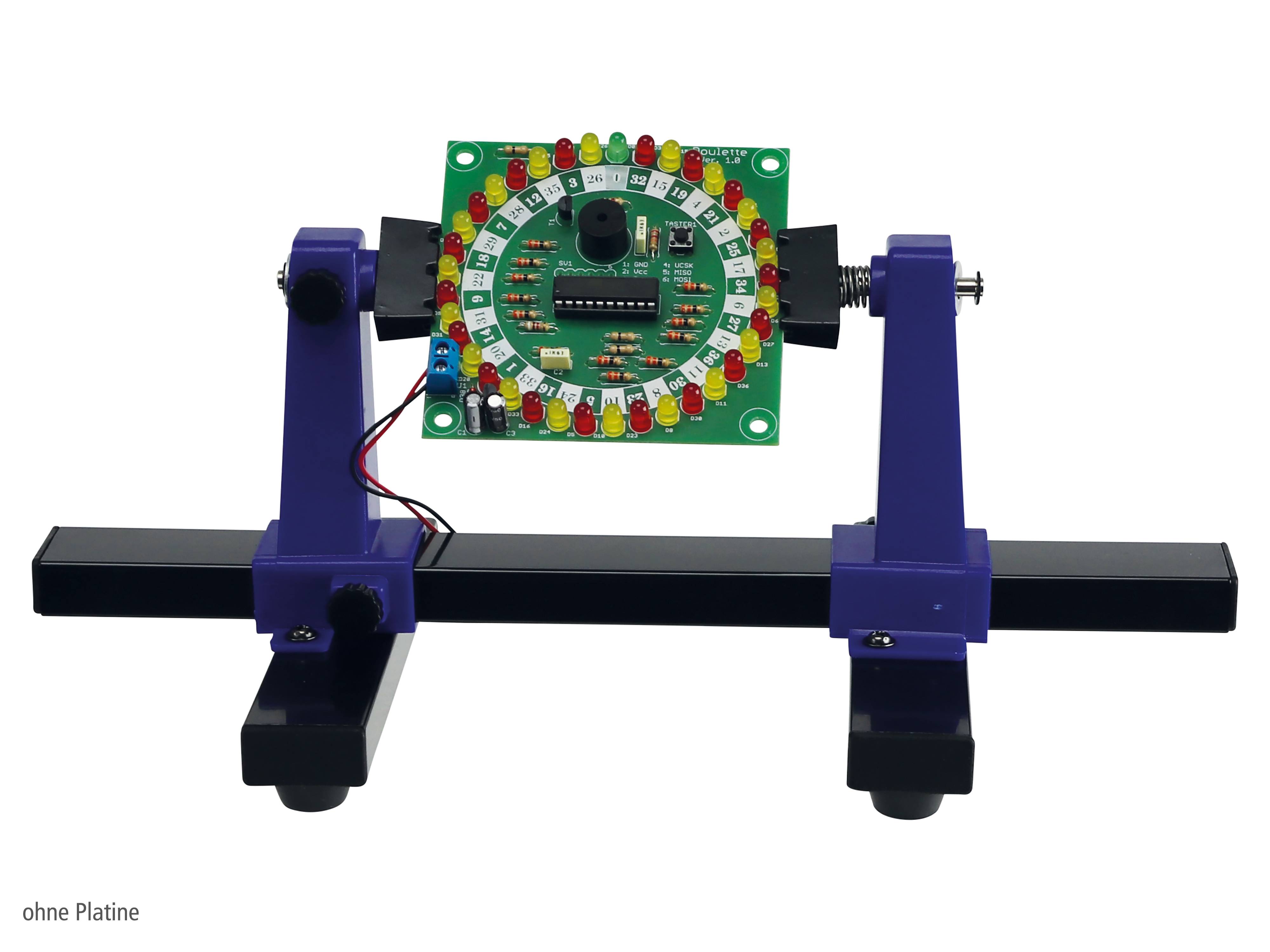 Ein Lötübungs-Kit, das auf einem Ständer befestigt ist und eine Leiterplatte mit mehreren LEDs zeigt, die in einem Ring um einen zentralen Chip angeordnet sind.