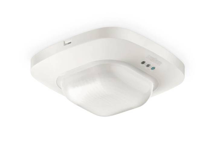 Ein weiß montierter Bewegungsmelder mit Kuppelabdeckung und zwei kleinen Anzeigelichtern, geeignet für den Innenbereich.