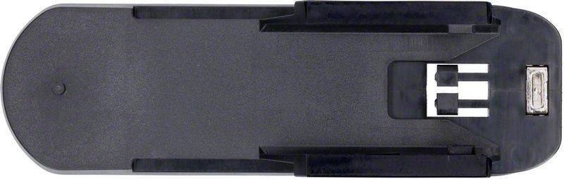 Eine große schwarze Foldbackklammer, von oben betrachtet, mit den nach außen ragenden Metallklemmteilen, die auf einer flachen Oberfläche liegt.