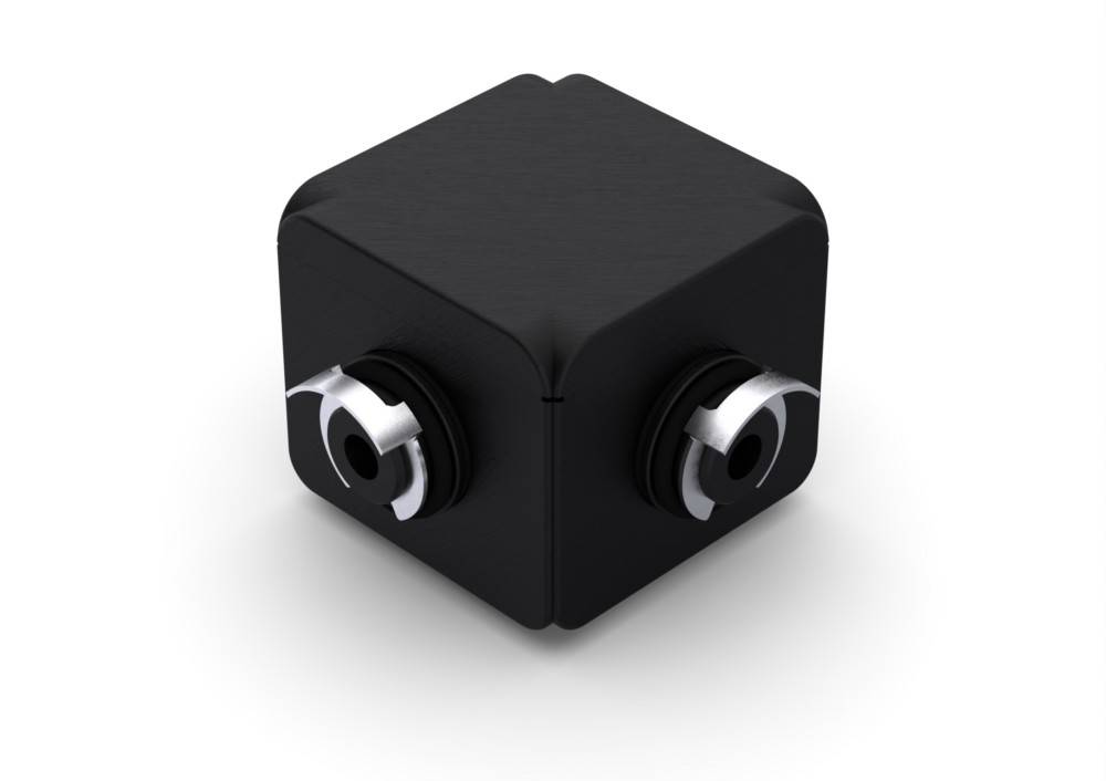 Ein schwarzer Würfel mit silbernen kreisförmigen Elementen auf jeder sichtbaren Seite, die dualen Kameraobjektiven ähneln.