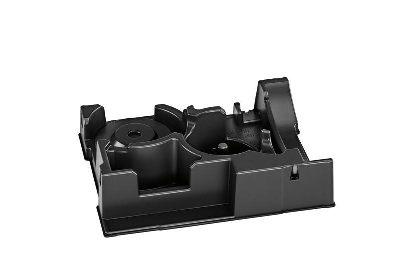 Eine schwarze Plastikkomponente mit mehreren Fächern, Schlitzen und Rillen, höchstwahrscheinlich Teil einer größeren Baugruppe oder eines Verpackungssystems.