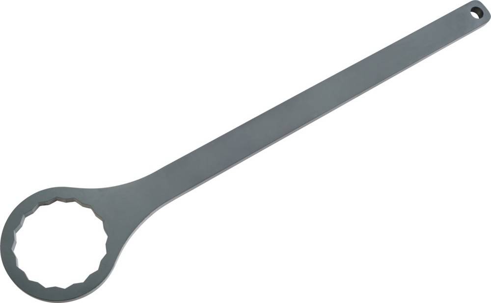 Ein großer, metallischer Schraubenschlüssel, der diagonal auf einer einfarbig weißen Oberfläche liegt.