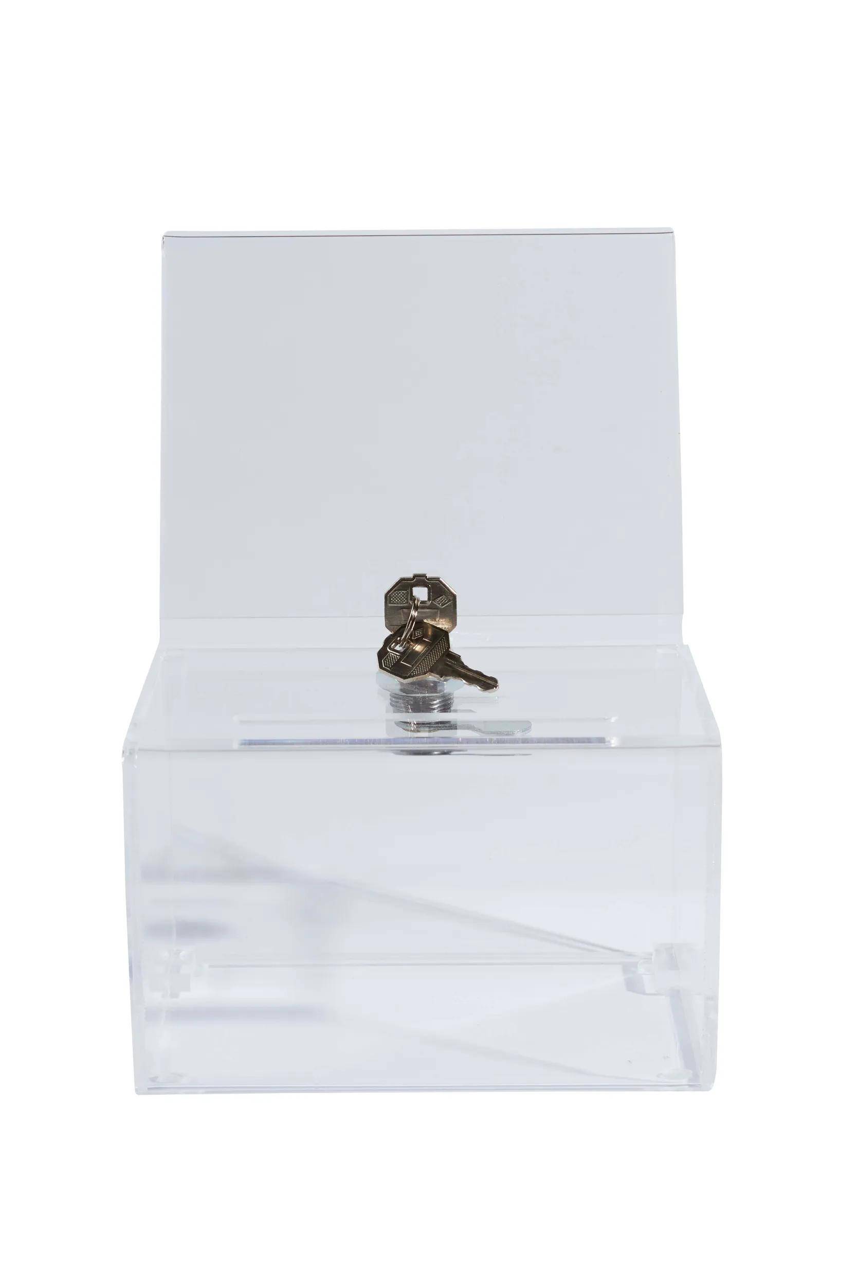 Eine transparente Wahlurne mit Schloss und Schlüssel oben sitzt leer und einsatzbereit für eine Wahl oder Abstimmungsveranstaltung.