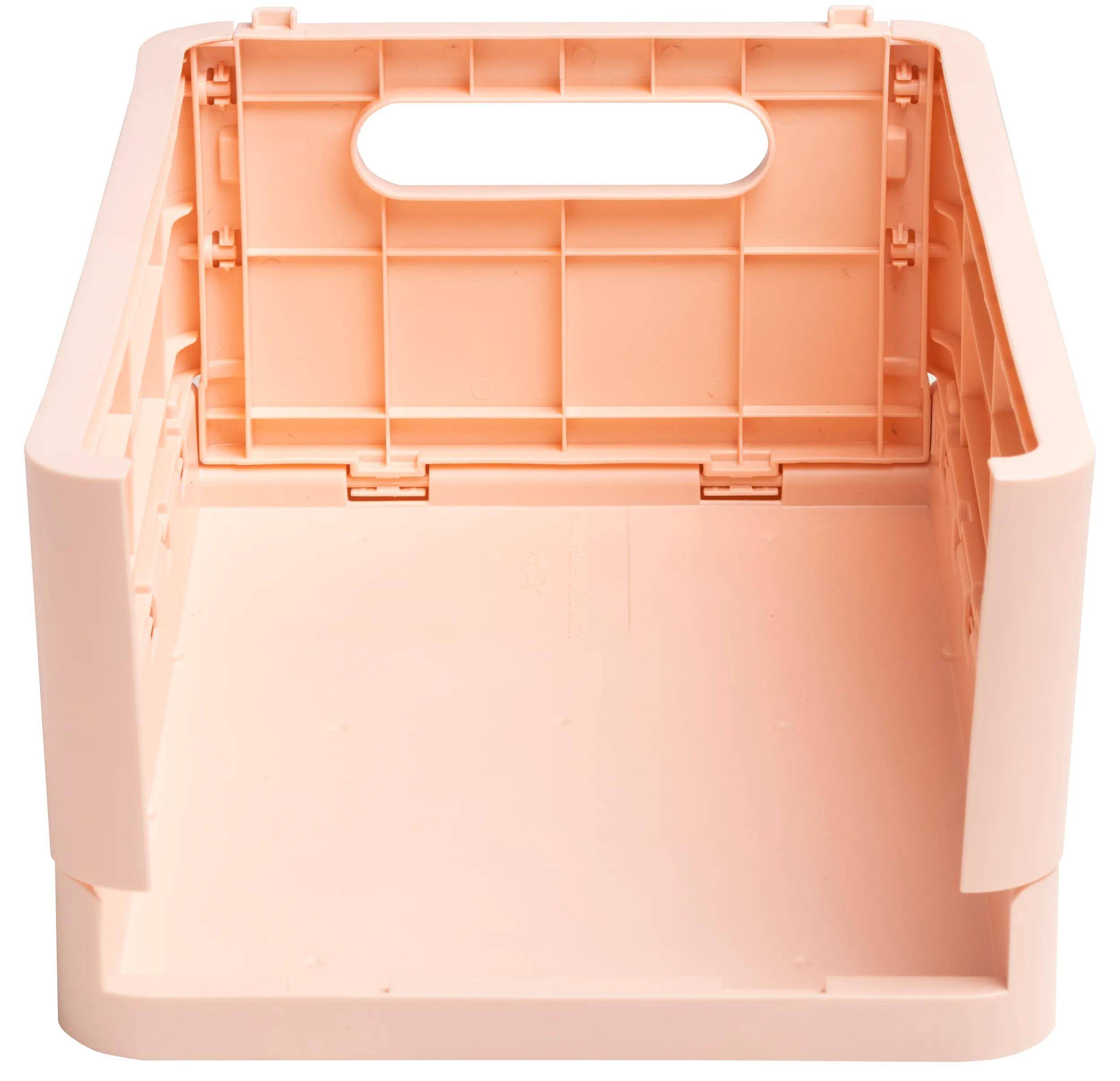 Ein pfirsichfarbener, offener Kunststoff-Lagerbehälter mit Griff, von vorne betrachtet, zeigt seinen Innenraum und glatte Oberfläche.