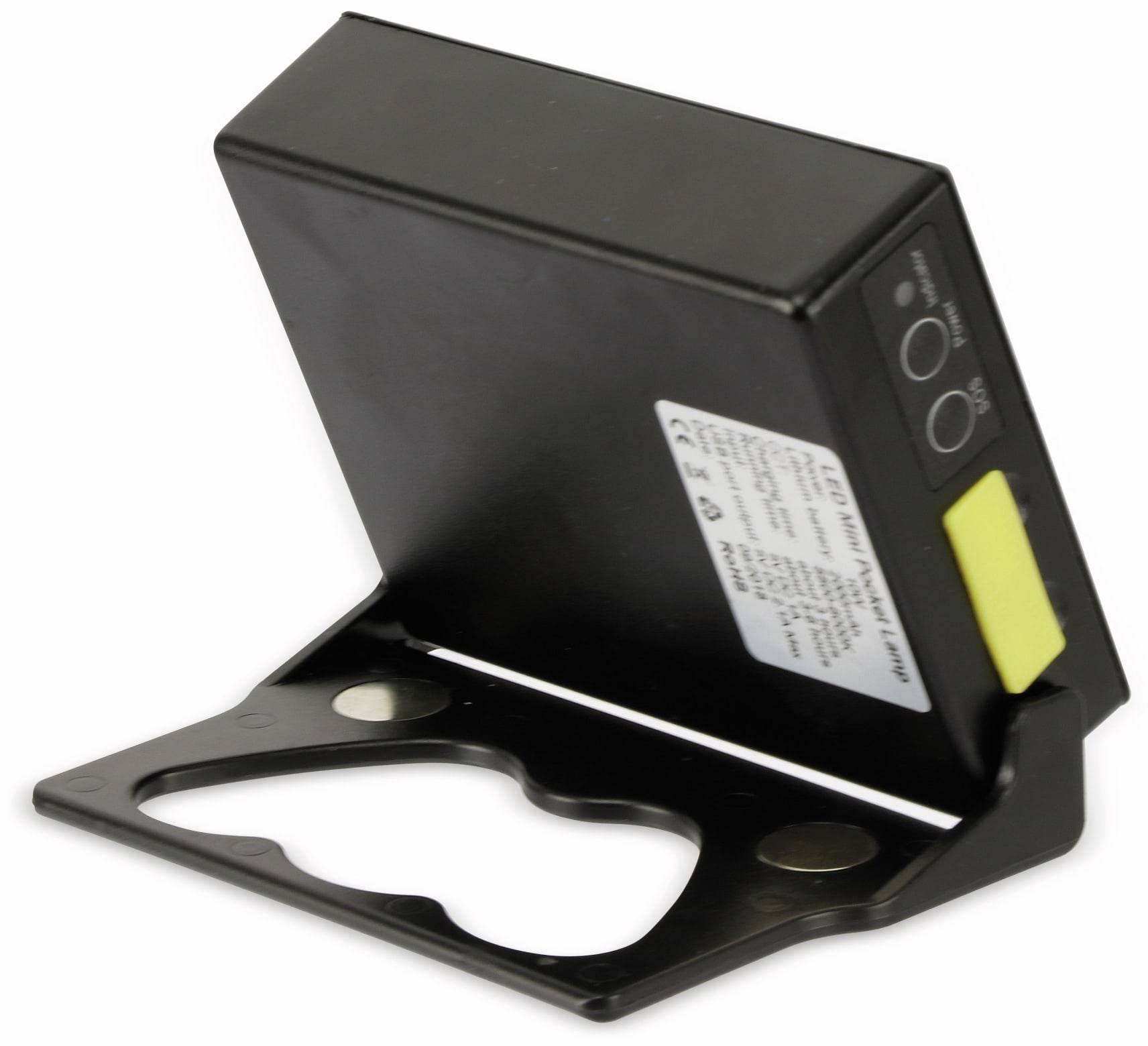 Ein kleines schwarzes Batterieladegerät mit einem Etikett und LED-Anzeigen wird auf einer Halterung gezeigt. Das Gerät hat einen gelben Warnaufkleber.