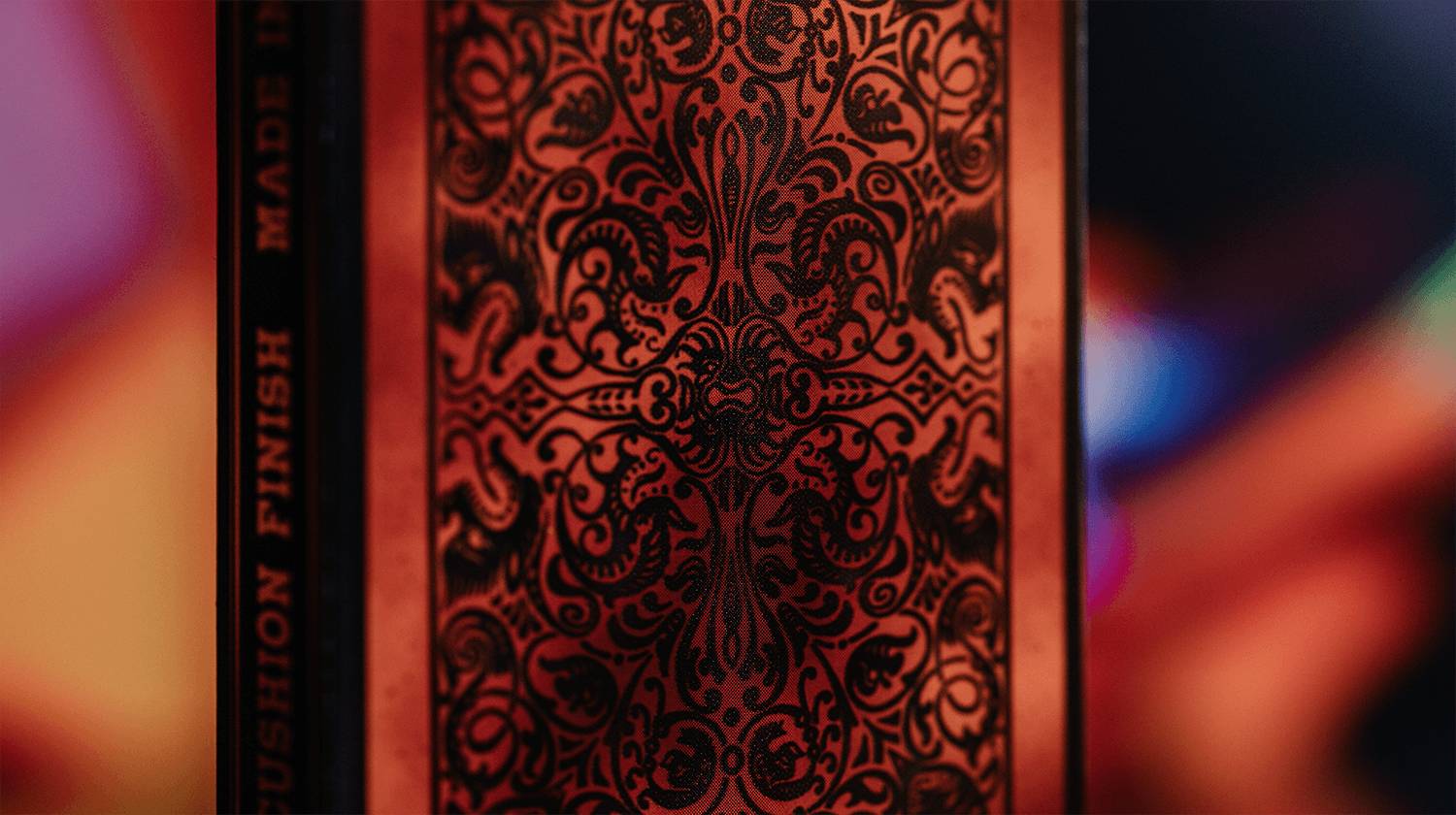 Nahaufnahme der Rückseite einer dekorativen Karte mit verziertem rot-schwarzem Muster und vertikalem „LONDON FASHION