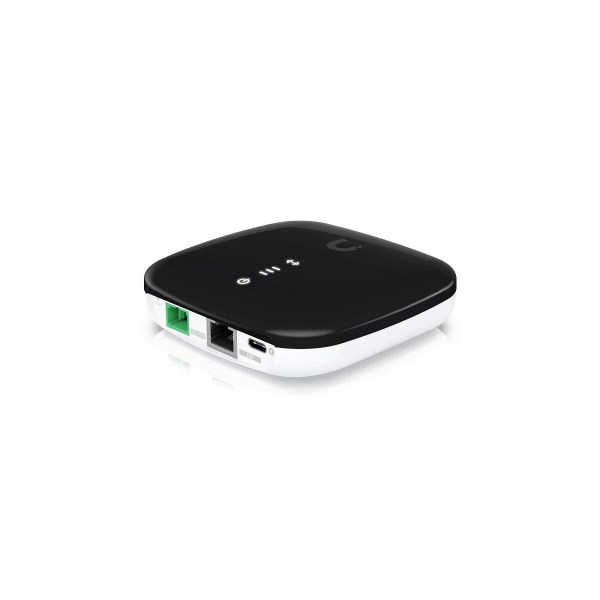 Ein kleiner, schwarz-weißer kabelloses Modem mit mehreren Anschlüssen auf einer Seite, darunter Ethernet- und USB-Verbindungen, auf weißem Hintergrund.