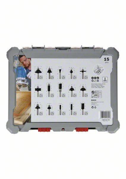 Bosch Fräsersatz-Verpackung, die 15 Stücke mit Abbildungen der einzelnen Fräsertypen zeigt. Bietet Anwendungen zum Holzfräsen und -schneiden.