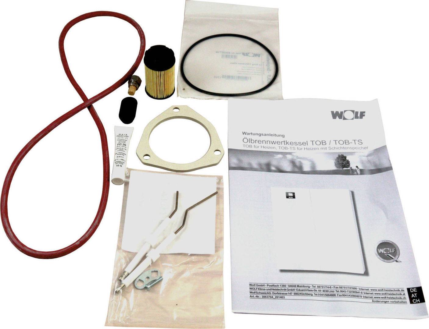 Kesselservice-Kit mit roter Dichtungsschleife, Filter, Dichtungen, Kleinteilen und Wolf-Installationshandbuch auf weißem Hintergrund.