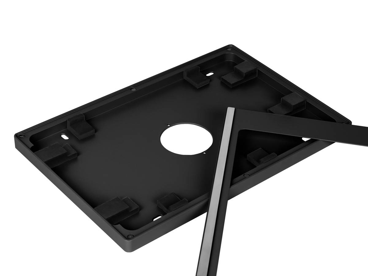 Ein schwarzer rechteckiger Kunststoffrahmen mit einem kreisförmigen Loch in der Mitte und Befestigungshalterungen in den Ecken.