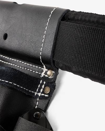 Nahaufnahme eines schwarzen Lederholsters mit kontrastierender weißer Naht und Metallnieten. Das Holster ist an einem dicken schwarzen Riemen befestigt.