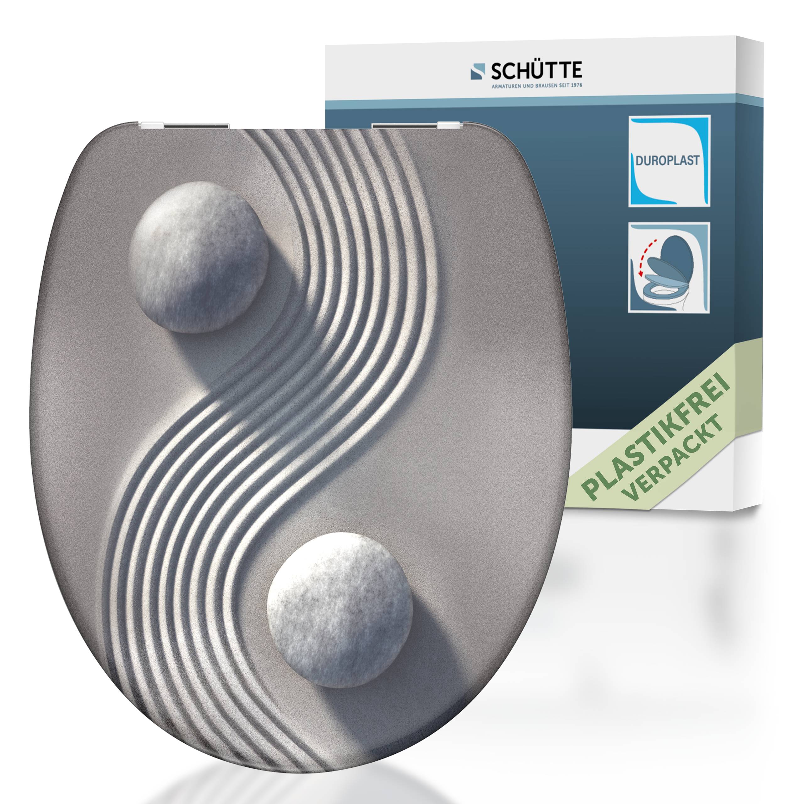 Ein Toilettensitz mit strukturiertem, welligem Design und zwei steinartig aussehenden Elementen. Die Verpackung wirbt mit „plastikfrei verpackt