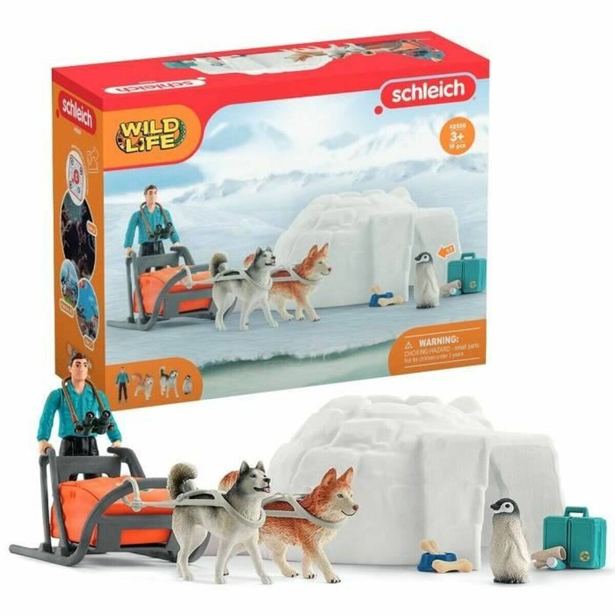 Schleich Wild Life Spielzeugset mit einem Schlittenfahrer, zwei Schlittenhunden, einem Iglu, einem Pinguin und Gepäck in einer verschneiten Arktisszene.