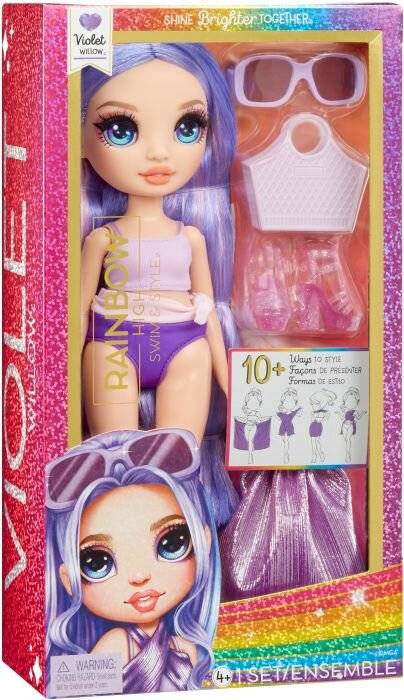 Rainbow High Violet Willow Modepuppe in einer Schachtel, mit zusätzlichen Outfitteilen, Schuhen und Zubehör, die durch die Verpackung sichtbar sind.