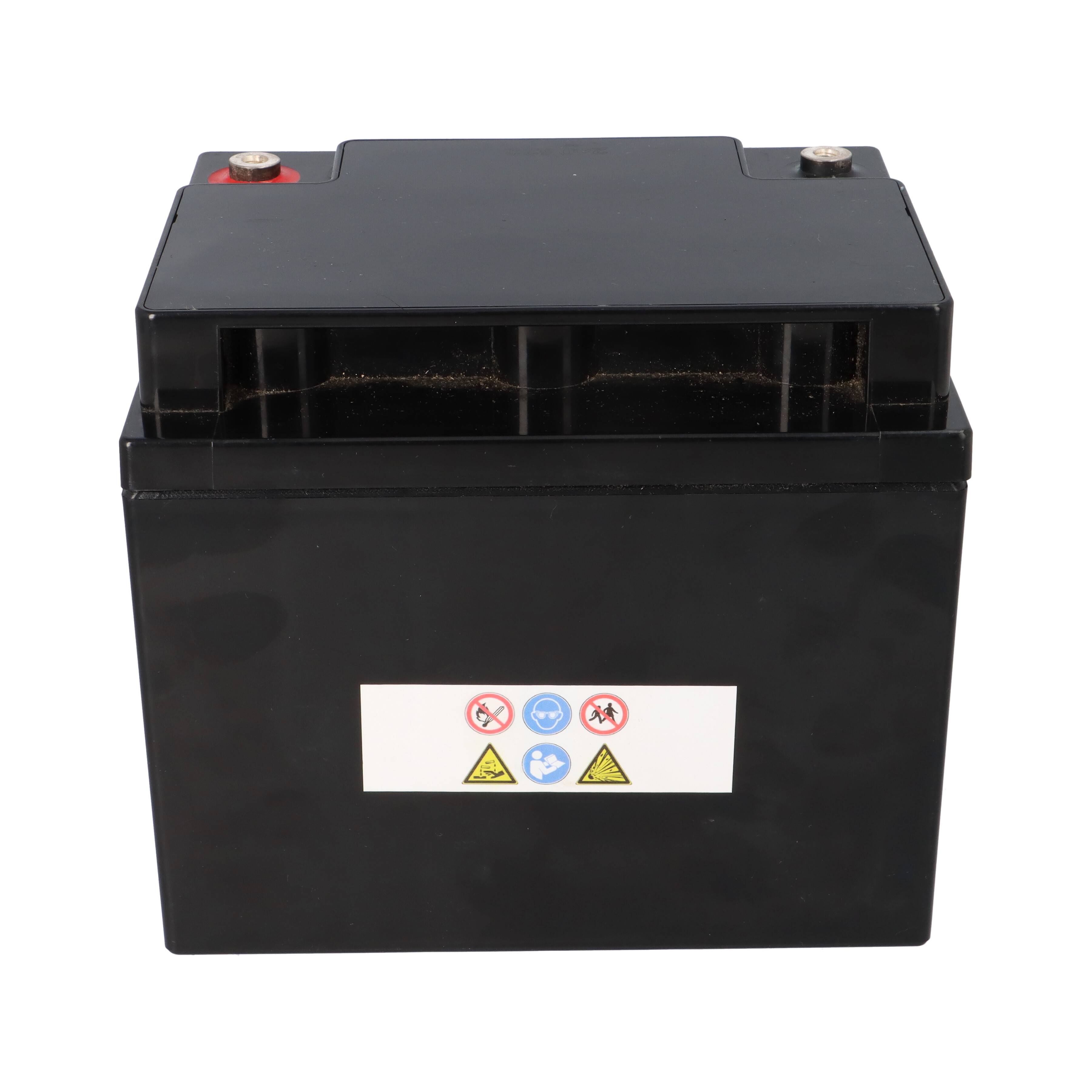 Eine schwarze Autobatterie mit Anschlusspolklemmen oben und Sicherheitssymbolen auf der Vorderseite.